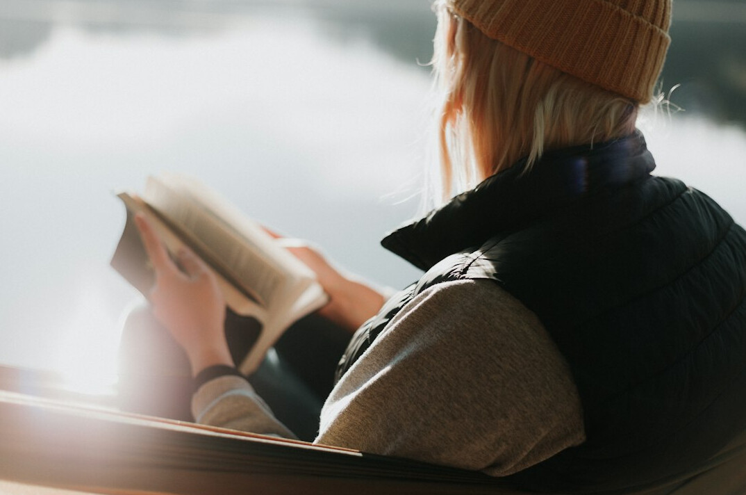 person reading book morning