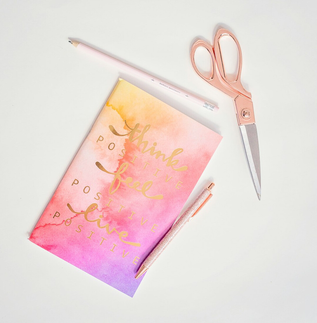 Notebook and pen on a desk for journaling